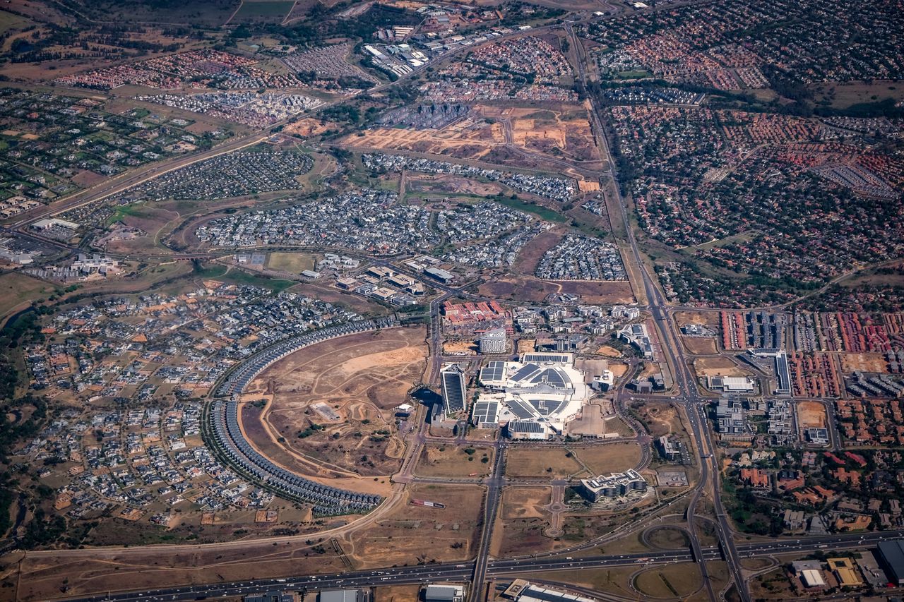 Aerial view showcasing an urban cityscape with unique architectural structures and sprawling landscapes.